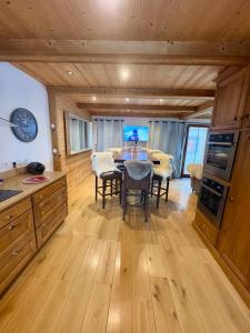 a kitchen and dining room with a table and chairs at Chalet Beaufort in Saint-Martin-de-Belleville
