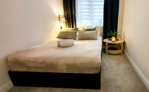 a bedroom with a large bed with a window at View Apartments Gorlice in Gorlice