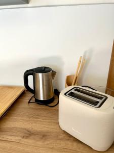 a toaster sitting on top of a wooden table at Grand Studio Lumineux & Rénové & Climatisé in Saint-Denis