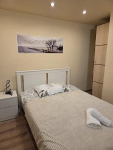 a bedroom with a bed and a painting on the wall at Willa MARSI in Stalowa Wola