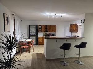 a kitchen and dining room with a table and chairs at Willa MARSI in Stalowa Wola