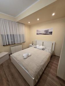 a bedroom with a bed with a stuffed animal on it at Willa MARSI in Stalowa Wola