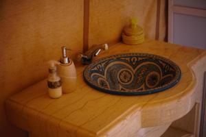 a bathroom sink with a plate on a counter at Camel luxury camps Merzouga in Merdani +68 photos