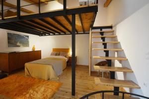 a bedroom with a loft bed and a ladder at Agapi in Kissamos