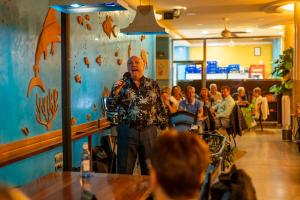 a man standing in front of a crowd in a restaurant at Apartamentos La Jabega in Fuengirola