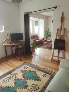 a living room with a couch and a table at Charme et authenticité pour 4 personnes 