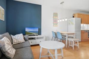 a living room with a couch and a table at Fewo Henri in Zempin +7 photos