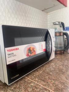 a toaster on a kitchen counter with a box on it at DrOmid in Maţār as Sīb ad Duwalī