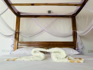 two towels laying on a bed in a bedroom at LiIi Villa Sri Lanka in Aluthgama