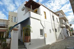 a white building with a potted plant on the side at Agapi in Kissamos