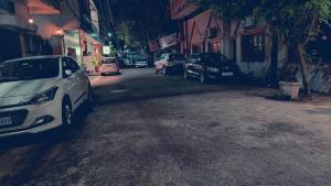 a white car parked on the side of a street at Hotel Pilgrim Near Golden Temple in Amritsar