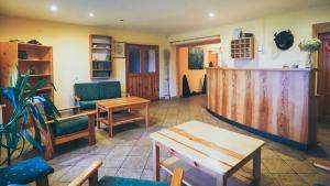 a living room with chairs and a table and a counter at Chata Kačerov in Kašperské Hory +9 photos