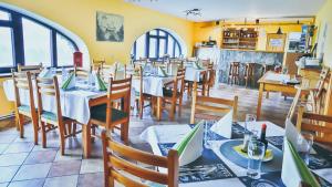 a dining room with tables and chairs in a restaurant at Chata Kačerov in Kašperské Hory