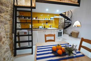 a kitchen with a table with a bowl of oranges on it at Agapi in Kissamos
