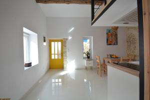 a living room with a yellow door and a dining room at Agapi in Kissamos +16 photos