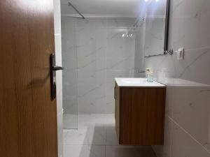 a bathroom with a shower and a sink and a mirror at Ithakis Rooms in Athens