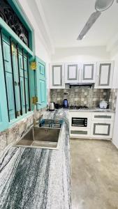 a kitchen with white cabinets and a sink at Vintage 83 Tangalle in Tangalle