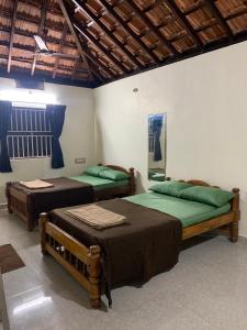 En eller flere senge i et værelse på Vilanee Retreat