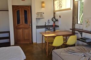 a room with a kitchen and a table and chairs at OPN Guest House Ilhabela in Ilhabela +34 photos