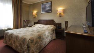 a hotel room with a bed and a television at Hotel Meslay Republique in Paris