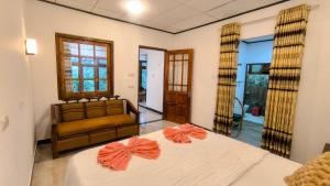 Ένα ή περισσότερα κρεβάτια σε δωμάτιο στο Sri Bhavan Ella