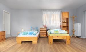 a bedroom with two twin beds and wooden furniture at Apartment A66 in Gründau