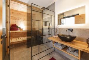 a bathroom with a glass shower and a sink at Schlicki's Bergchalet in Filzmoos