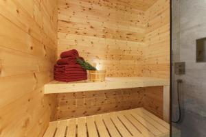 a sauna with a wooden paneled wall at Schlicki's Bergchalet in Filzmoos +18 photos