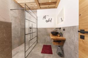 a bathroom with a shower and a sink at Schlicki's Bergchalet in Filzmoos