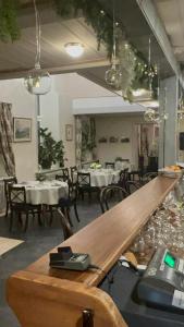 a dining room with tables and chairs and a counter at Pilsbrūzis in Odziena +15 photos
