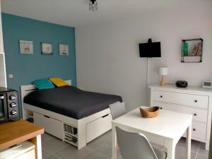 グレウー・レ・バンにあるStudio Le Provence 2 étoiles tout équipé, wifi, parkingのベッドとテーブルと机のある寝室
