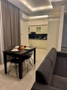 a living room with a table and a couch at Soğular Apartments 1 in Aglantzia
