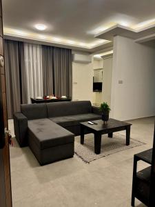 a living room with a couch and a coffee table at Soğular Apartments 1 in Aglantzia