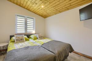 a bedroom with a bed in a room with a window at Gospodarstwo Zacisze in Kowary