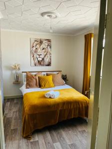 a bedroom with a bed with a tiger painting on the wall at The Chroma Cottage in Cock Hill +7 photos