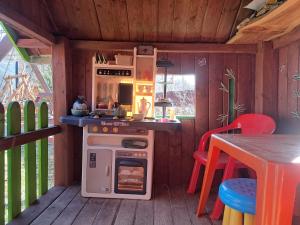 a small kitchen with a stove and a table at Gospodarstwo Zacisze in Kowary
