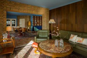 a living room with a couch and a table at Stylish Apartment Zander On The Eider River Bend in Süderstapel +8 photos