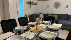 a dining room with a table with plates and wine glasses at Zum Rosenhügel in Hellenthal