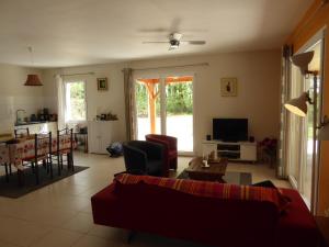 a living room with a couch and a table at Villa Pepy in Salviac +25 photos