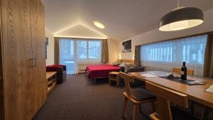a hotel room with a bedroom and a living room at Haus Aida in Saas-Fee