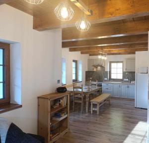 a kitchen with a table and a dining room at Chata Polárka in Terchová
