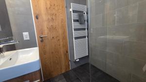 a bathroom with a sink and a glass shower at Haus Aida in Saas-Fee +46 photos