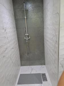 a shower with a glass door in a bathroom at Haytam in Sale