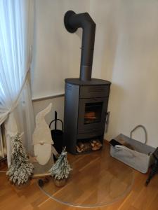 a wood stove in a room with christmas trees at Ferienwohnung Sartorius in Bensheim