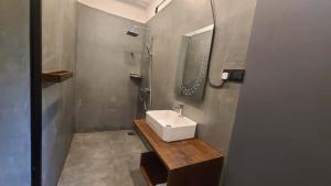 a bathroom with a sink and a shower at Ametz Politak in Weligama