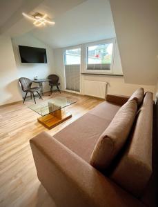 a living room with a couch and a table at Steinfelderhof in Kröv