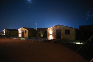 a group of huts at night in the desert at Al Reem Ranch in Ras al Khaimah