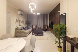 a living room with a couch and a table at كنكون - Cancun in King Abdullah Economic City