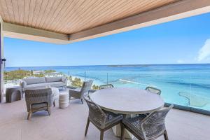 a dining room with a view of the ocean at Beachfront 3 bedroom Luxury Residence in Nassau