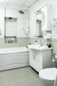 a bathroom with a tub and a sink and a toilet at Parliament Hotel & Restaurant in Baku